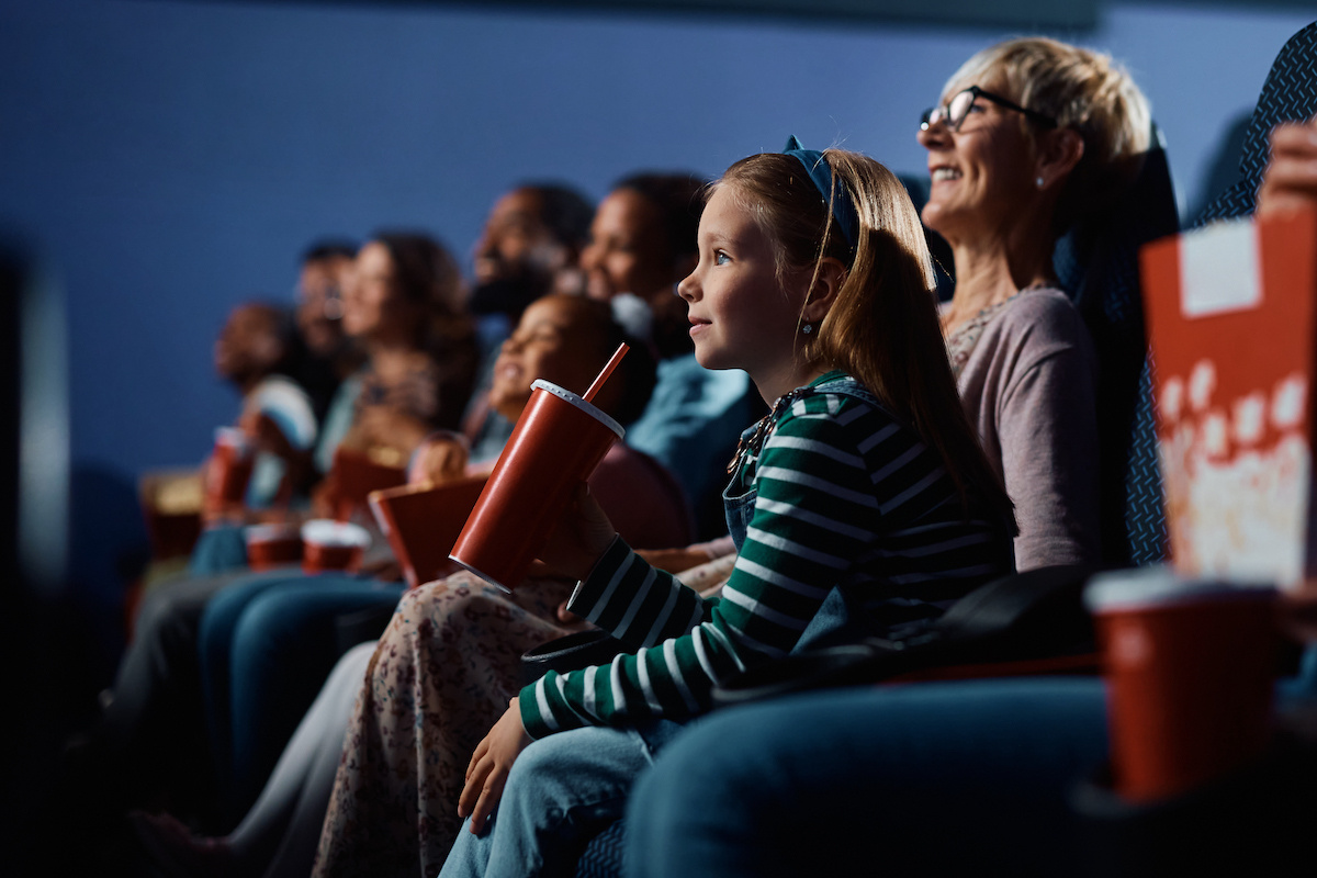 girl watching a movie at a movie theater